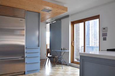 This is an example of a contemporary kitchen in New York with stainless steel appliances.