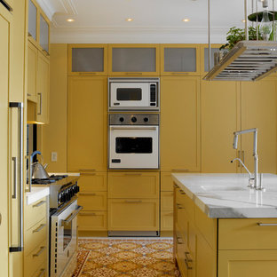 Kitchen - contemporary galley multicolored floor kitchen idea in New York with yellow cabinets, white appliances, shaker cabinets and a single-bowl sink