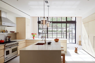 Example of a huge minimalist u-shaped white floor eat-in kitchen design in New York with an undermount sink, flat-panel cabinets, light wood cabinets, metallic backsplash, metal backsplash, stainless steel appliances, an island and white countertops