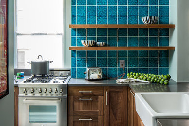 Example of a mid-sized eclectic l-shaped concrete floor and gray floor enclosed kitchen design in San Francisco with a farmhouse sink, shaker cabinets, dark wood cabinets, concrete countertops, blue backsplash, ceramic backsplash, stainless steel appliances, no island and gray countertops