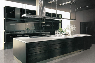 Example of a mid-sized minimalist galley marble floor open concept kitchen design in Milwaukee with flat-panel cabinets, black cabinets, quartzite countertops, stainless steel appliances and an island