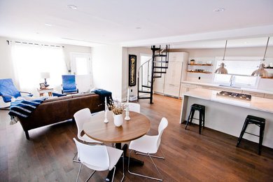 Open concept kitchen - large contemporary galley medium tone wood floor open concept kitchen idea in Toronto with a drop-in sink, shaker cabinets, white cabinets, quartzite countertops, white backsplash, ceramic backsplash, stainless steel appliances and a peninsula