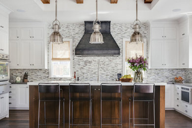 Inspiration for a large farmhouse u-shaped dark wood floor open concept kitchen remodel in San Francisco with an undermount sink, beaded inset cabinets, white cabinets, solid surface countertops, multicolored backsplash, matchstick tile backsplash, stainless steel appliances and an island