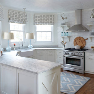 Example of a transitional u-shaped eat-in kitchen design in Atlanta with a farmhouse sink, shaker cabinets, white cabinets, white backsplash, subway tile backsplash, stainless steel appliances and granite countertops