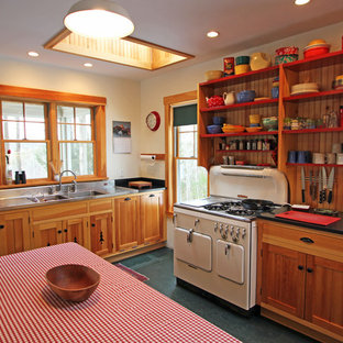 Design ideas for a mid-sized country u-shaped eat-in kitchen in Portland Maine with a double-bowl sink, open cabinets, medium wood cabinets, white appliances, with island, stainless steel benchtops, timber splashback and black floor.
