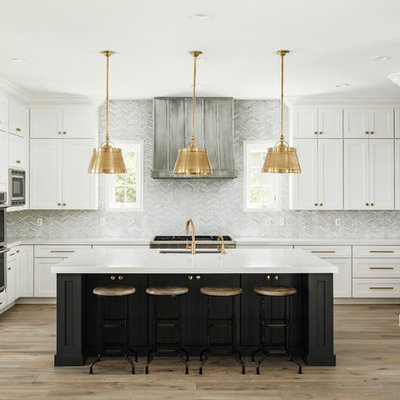 Large transitional u-shaped light wood floor and beige floor open concept kitchen photo in Phoenix with an undermount sink, shaker cabinets, quartz countertops, gray backsplash, marble backsplash, stainless steel appliances, an island and white countertops