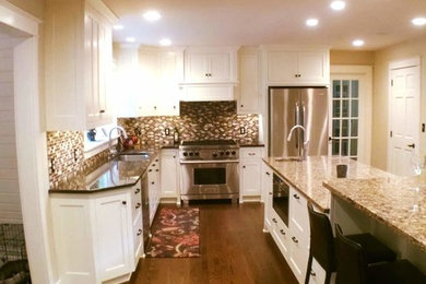 Inspiration for a huge timeless l-shaped dark wood floor eat-in kitchen remodel in Other with an undermount sink, shaker cabinets, white cabinets, quartz countertops, multicolored backsplash, mosaic tile backsplash, stainless steel appliances and two islands