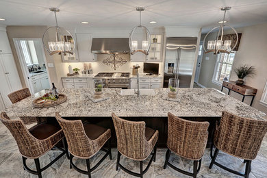 Large elegant u-shaped ceramic tile and beige floor eat-in kitchen photo in Other with a farmhouse sink, recessed-panel cabinets, white cabinets, granite countertops, stainless steel appliances and an island