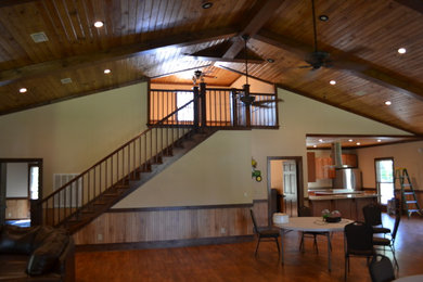 Mid-sized mountain style u-shaped medium tone wood floor kitchen photo in Atlanta with raised-panel cabinets, brown cabinets, granite countertops, stainless steel appliances and an island