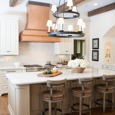 Example of a classic kitchen design in Birmingham with raised-panel cabinets, white cabinets and white backsplash