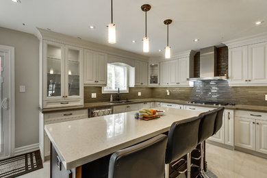 Example of a transitional kitchen design in Toronto with an island and white cabinets