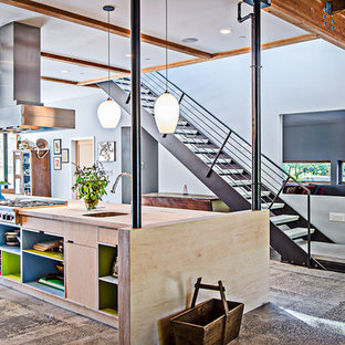 Industrial kitchen inspiration - Urban kitchen photo in Seattle with wood countertops and open cabinets