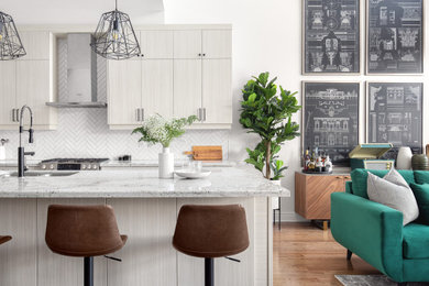 Inspiration for a mid-sized mid-century modern galley medium tone wood floor and brown floor kitchen remodel in Toronto with an undermount sink, flat-panel cabinets, gray cabinets, white backsplash, an island and gray countertops