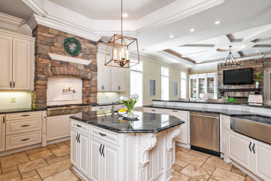 Large elegant u-shaped brown floor kitchen photo in Charlotte with a farmhouse sink, raised-panel cabinets, white cabinets, white backsplash, porcelain backsplash, stainless steel appliances, an island and black countertops