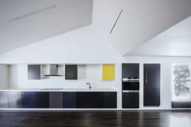 Design ideas for a contemporary single-wall open plan kitchen in Los Angeles with black cabinets and feature lighting.
