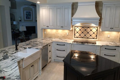Open concept kitchen - traditional open concept kitchen idea in Tampa with raised-panel cabinets, white cabinets, quartzite countertops, an island and white countertops