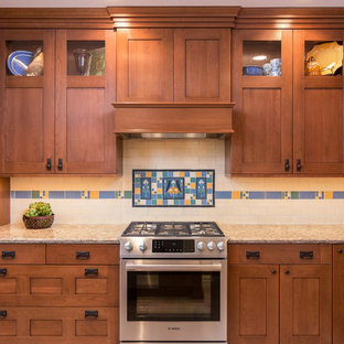 Craftsman eat-in kitchen inspiration - Example of an arts and crafts eat-in kitchen design in Los Angeles with ceramic backsplash, an island, shaker cabinets, medium tone wood cabinets, granite countertops, beige backsplash and stainless steel appliances