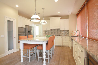 Example of a mid-sized minimalist galley light wood floor enclosed kitchen design in Los Angeles with a single-bowl sink, recessed-panel cabinets, white cabinets, granite countertops, multicolored backsplash, mosaic tile backsplash, stainless steel appliances and an island