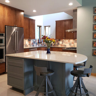 Mid-sized modern u-shaped eat-in kitchen in Other with an undermount sink, flat-panel cabinets, medium wood cabinets, quartz benchtops, multi-coloured splashback, slate splashback, stainless steel appliances, concrete floors, with island, grey floor and grey benchtop.