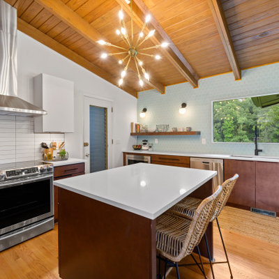 Enclosed kitchen - mid-sized 1960s u-shaped light wood floor, brown floor and exposed beam enclosed kitchen idea in Birmingham with an undermount sink, flat-panel cabinets, medium tone wood cabinets, quartz countertops, blue backsplash, ceramic backsplash, stainless steel appliances, an island and white countertops