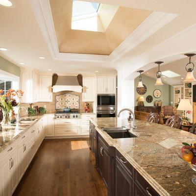 Inspiration for a huge timeless open concept kitchen remodel in San Francisco with an undermount sink, raised-panel cabinets, beige cabinets, granite countertops, multicolored backsplash, stainless steel appliances and an island
