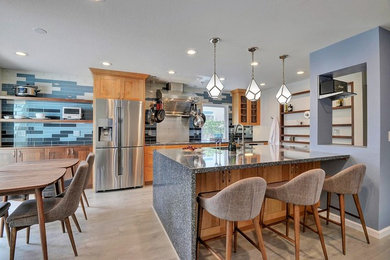 Photo of a medium sized contemporary kitchen/diner in San Francisco with a single-bowl sink, shaker cabinets, engineered stone countertops, glass tiled splashback, stainless steel appliances and an island.