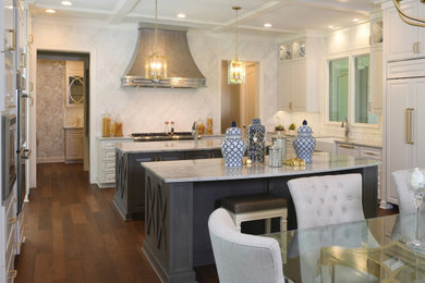 Large eclectic u-shaped dark wood floor and brown floor eat-in kitchen photo in Houston with an undermount sink, raised-panel cabinets, white cabinets, marble countertops, white backsplash, marble backsplash, stainless steel appliances, two islands and white countertops
