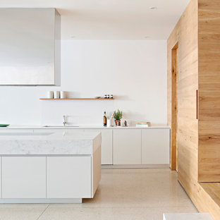 Design ideas for a large contemporary galley kitchen in Melbourne with an undermount sink, marble benchtops, white splashback, stone tile splashback, concrete floors, with island, white floor, white benchtop, flat-panel cabinets and white cabinets.