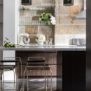Photo of a contemporary kitchen in Sydney with flat-panel cabinets, dark wood cabinets, beige splashback, dark hardwood floors, brown floor and grey benchtop.