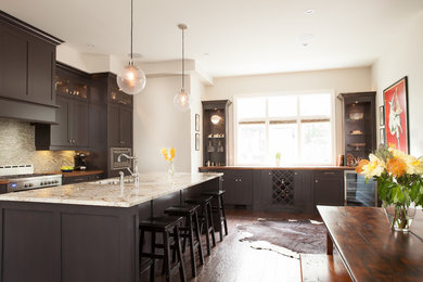 Example of a transitional eat-in kitchen design in Toronto with shaker cabinets, gray cabinets, wood countertops, gray backsplash, glass tile backsplash and stainless steel appliances