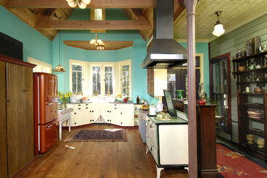 Large mountain style galley enclosed kitchen photo in Tampa with a double-bowl sink, flat-panel cabinets, white cabinets, colored appliances and no island