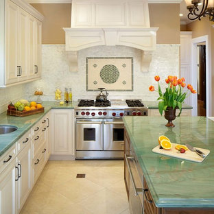 Photo of an expansive traditional u-shaped eat-in kitchen in San Francisco with an undermount sink, raised-panel cabinets, white cabinets, quartzite benchtops, white splashback, stone tile splashback, panelled appliances, porcelain floors and with island.
