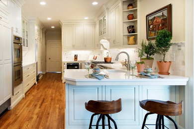 Example of a large transitional u-shaped eat-in kitchen design in Nashville with a double-bowl sink, raised-panel cabinets, beige cabinets, quartzite countertops, multicolored backsplash, subway tile backsplash and paneled appliances