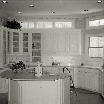 View of Kitchen across Island to Cabinets with Clerestory Windows Above
