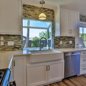 View of One side of the Kitchen, Prominent Sink, and a Panoramic window.