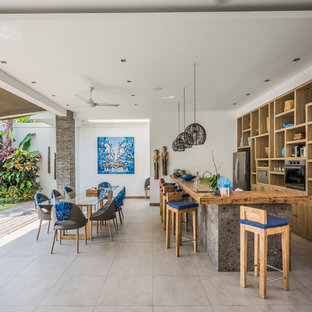 Design ideas for a tropical galley open plan kitchen in Perth with open cabinets, medium wood cabinets, wood benchtops, stainless steel appliances, a peninsula, grey floor and brown benchtop.