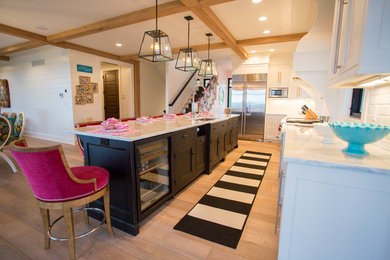 Example of a large transitional l-shaped dark wood floor and brown floor eat-in kitchen design in Other with an undermount sink, shaker cabinets, white cabinets, marble countertops, white backsplash, subway tile backsplash, stainless steel appliances and an island