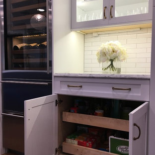 Large traditional kitchen appliance - Inspiration for a large timeless l-shaped medium tone wood floor and brown floor kitchen remodel in Philadelphia with an undermount sink, shaker cabinets, quartz countertops, white backsplash, ceramic backsplash, stainless steel appliances and an island