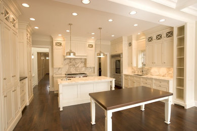 Large transitional u-shaped medium tone wood floor eat-in kitchen photo in Chicago with an island, white cabinets, marble countertops, white backsplash, stone slab backsplash, stainless steel appliances, an undermount sink and recessed-panel cabinets