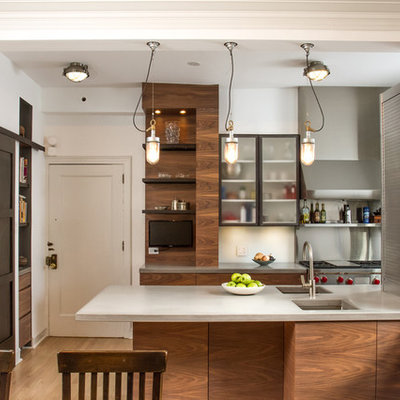 Inspiration for a transitional galley eat-in kitchen remodel in Chicago with an undermount sink, open cabinets, dark wood cabinets, concrete countertops, metallic backsplash and stainless steel appliances