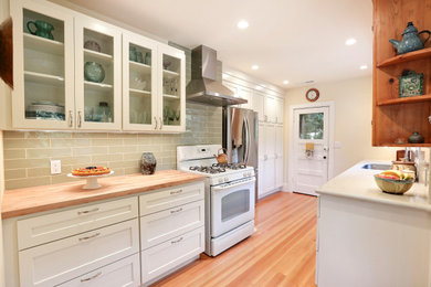 Small eclectic galley light wood floor eat-in kitchen photo in San Francisco with an undermount sink, shaker cabinets, white cabinets, wood countertops, green backsplash, subway tile backsplash and stainless steel appliances