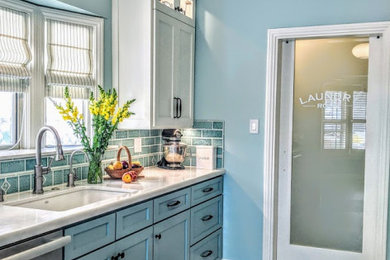 Example of a mid-sized beach style galley linoleum floor and white floor eat-in kitchen design in Los Angeles with a double-bowl sink, shaker cabinets, blue cabinets, quartz countertops, blue backsplash, porcelain backsplash, stainless steel appliances, no island and white countertops