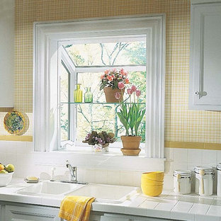 Photo of a traditional kitchen in Other with recessed-panel cabinets, white cabinets, tile benchtops, white splashback, ceramic splashback and an integrated sink.