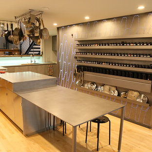 Contemporary l-shaped eat-in kitchen in San Francisco with an undermount sink, flat-panel cabinets, grey cabinets, zinc benchtops, grey splashback, metal splashback, panelled appliances, light hardwood floors, with island, beige floor and grey benchtop.