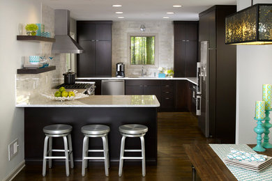 Inspiration for a contemporary u-shaped dark wood floor eat-in kitchen remodel in Atlanta with an undermount sink, flat-panel cabinets, dark wood cabinets, multicolored backsplash, stainless steel appliances, a peninsula and marble countertops