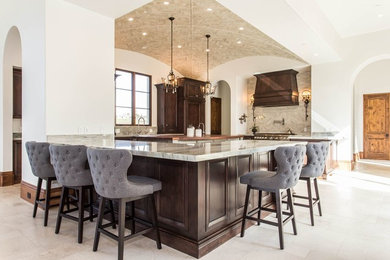 Large transitional u-shaped beige floor open concept kitchen photo in San Diego with a farmhouse sink, recessed-panel cabinets, dark wood cabinets, soapstone countertops, white backsplash, marble backsplash, stainless steel appliances, an island and gray countertops