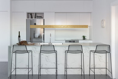 Modern inredning av ett linjärt kök med öppen planlösning, med en undermonterad diskho, släta luckor, vita skåp, vitt stänkskydd, rostfria vitvaror, en köksö och grått golv