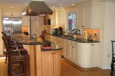 Example of a classic kitchen design in Boston with an undermount sink, recessed-panel cabinets and stainless steel appliances
