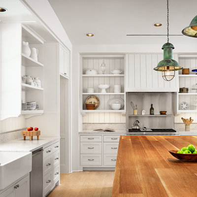 Large cottage l-shaped light wood floor kitchen photo in Houston with an island, open cabinets, white cabinets, marble countertops, stainless steel appliances, a farmhouse sink, white backsplash and wood backsplash