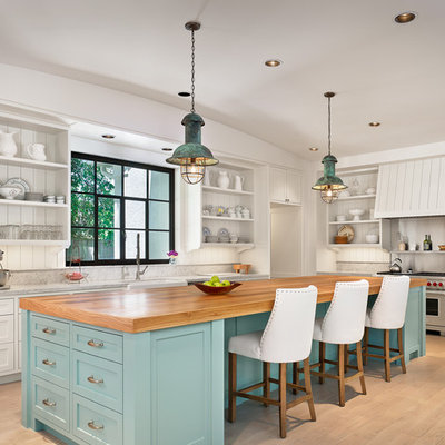 Inspiration for a large coastal l-shaped light wood floor kitchen remodel in Houston with a farmhouse sink, open cabinets, white cabinets, wood countertops, white backsplash, stainless steel appliances, an island and wood backsplash